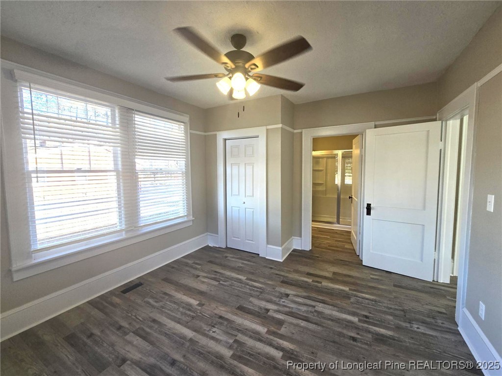 802 Dunn Road Fayetteville, NC 28312 - Photo 14 of 28 a view of an empty room with wooden floor and a window