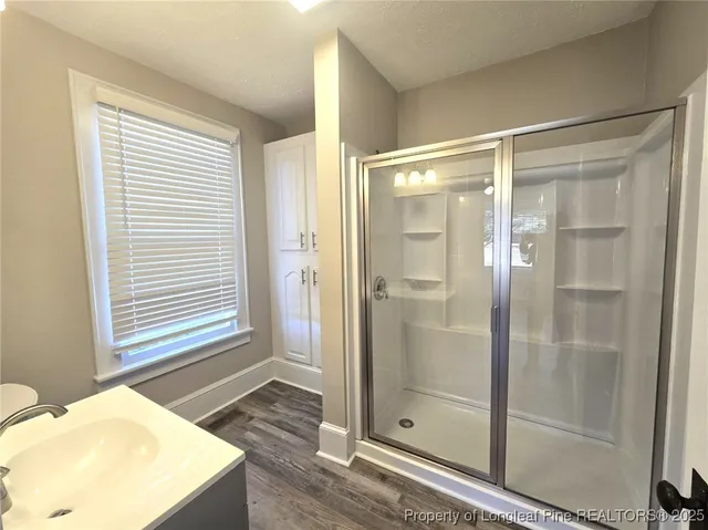 a bathroom with a shower and a sink