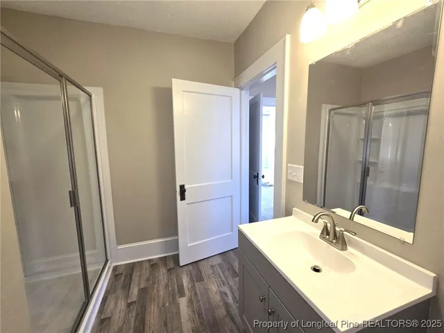a bathroom with a sink a mirror and a shower