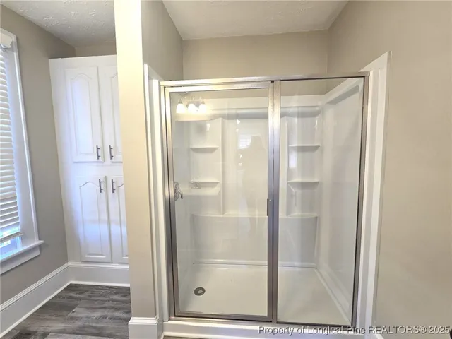 a bathroom with a glass shower door