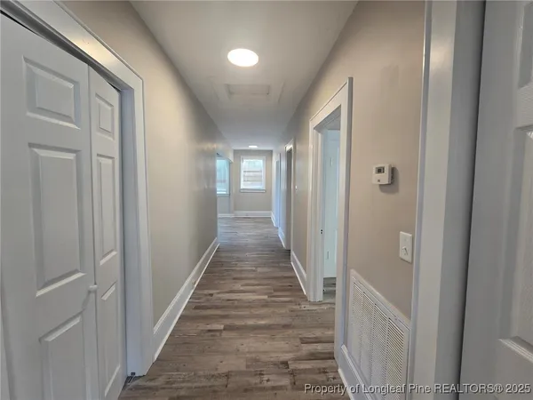 a view of a hallway with a wooden door