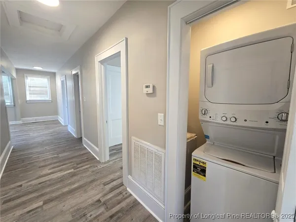 a view of washer and dryer with wooden floor