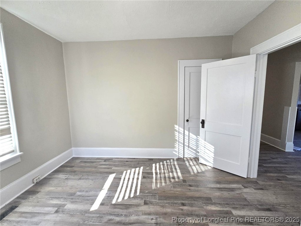 802 Dunn Road Fayetteville, NC 28312 - Photo 26 of 28 an empty room with wooden floor and windows
