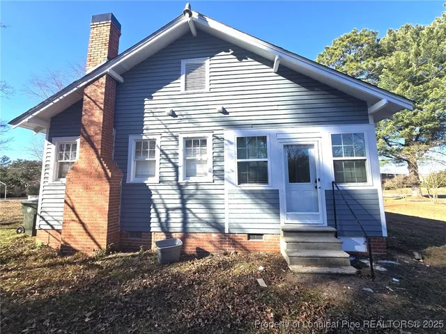 a view of house with backyard