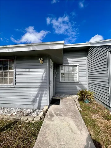a side view of a house with a yard