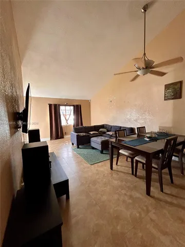 a view of a livingroom with furniture and a flat screen tv