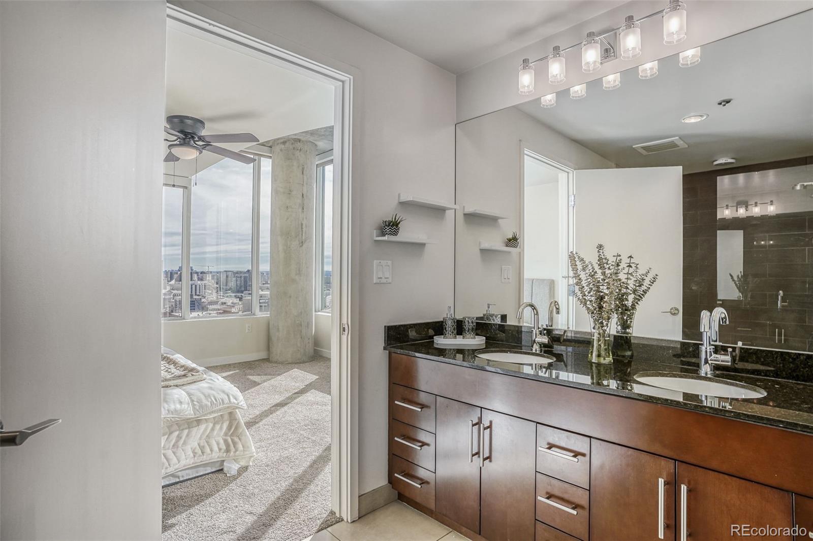 891 14th Street, Unit 1917 Denver, CO 80202 - Photo 15 of 29 a bathroom with double vanity and a mirror
