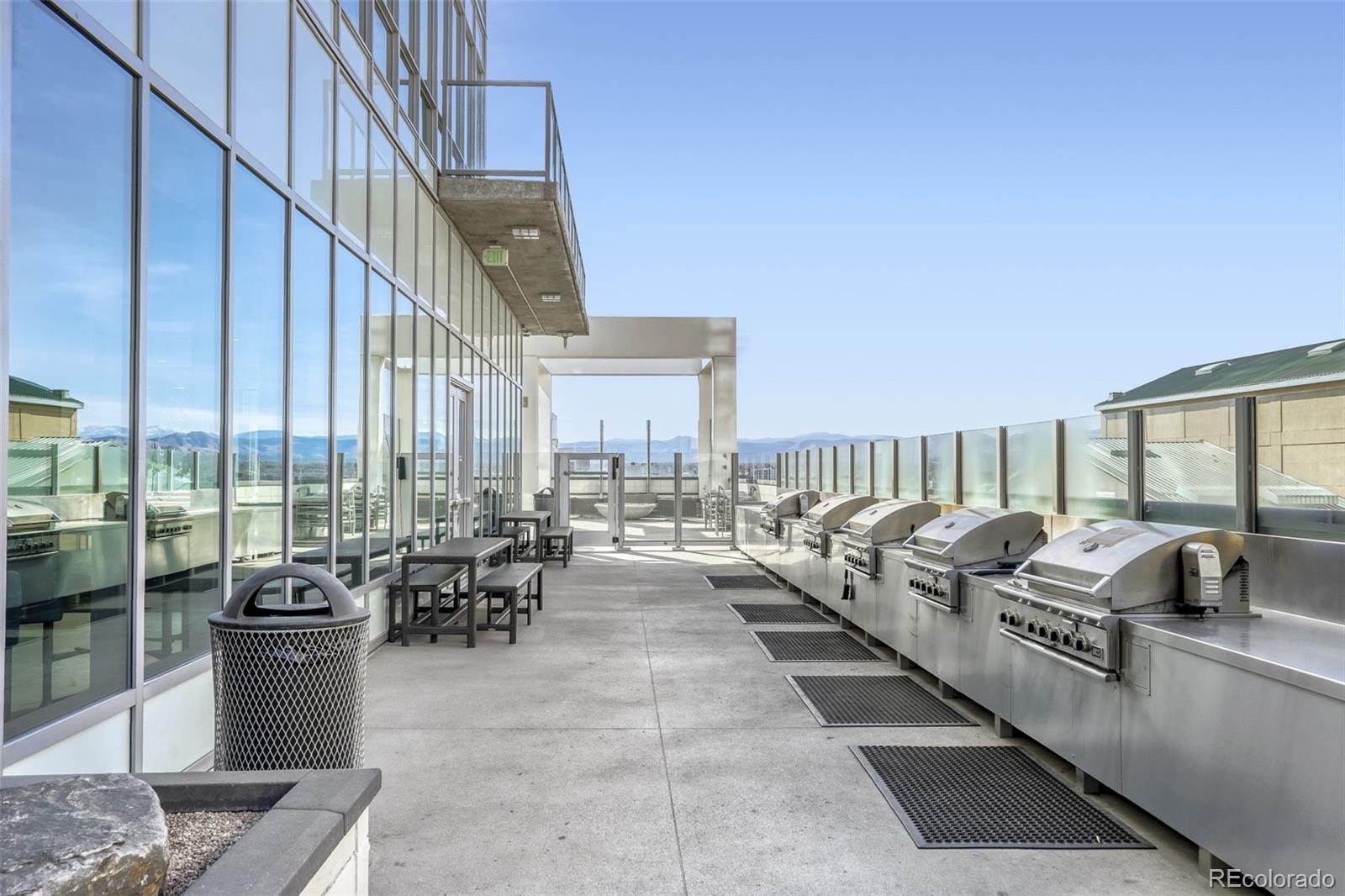 891 14th Street, Unit 1917 Denver, CO 80202 - Photo 24 of 29 a living room with patio furniture and a floor to ceiling window