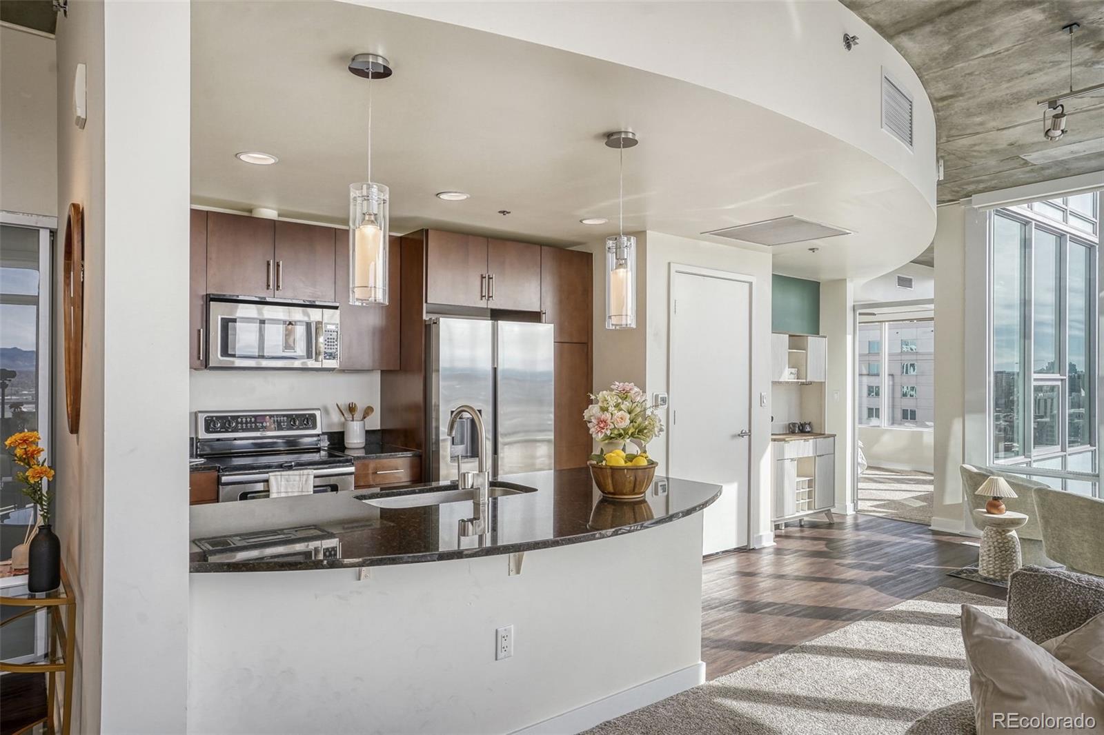 891 14th Street, Unit 1917 Denver, CO 80202 - Photo 10 of 29 a kitchen with stainless steel appliances granite countertop a refrigerator and a stove