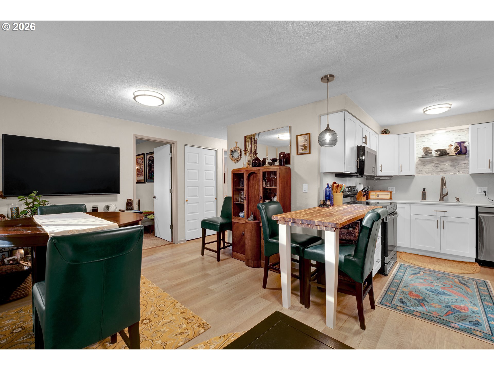 2060 20th Street Florence, OR 97439 - Photo 18 of 37 a view of a dining room kitchen with furniture and wooden floor