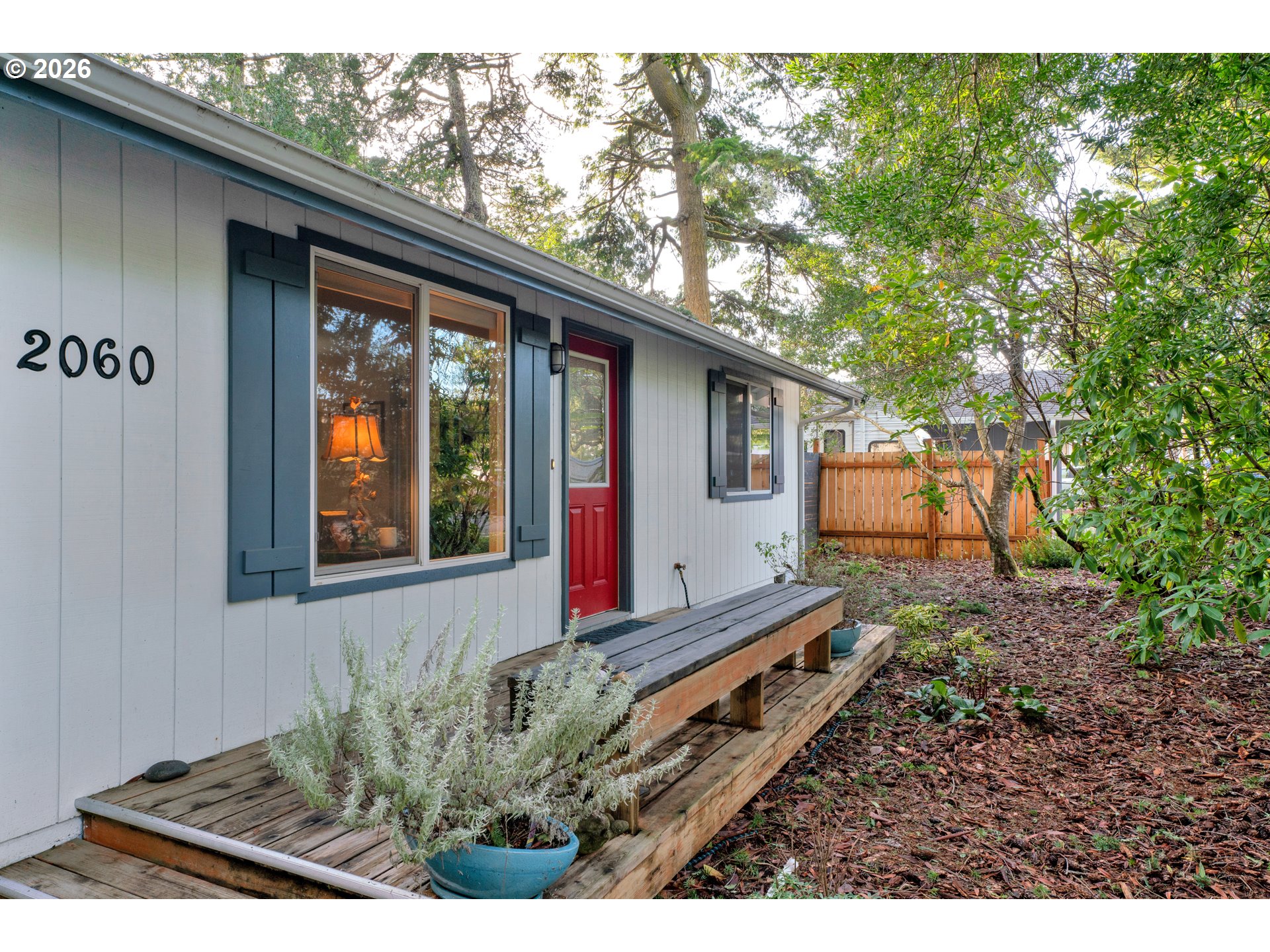 2060 20th Street Florence, OR 97439 - Photo 2 of 37 a view of backyard with deck and outdoor seating
