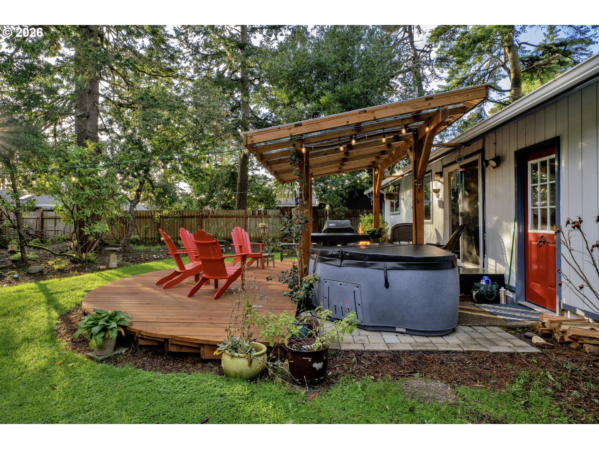 2060 20th Street Florence, OR 97439 - Photo 25 of 37 a backyard of a house with table and chairs