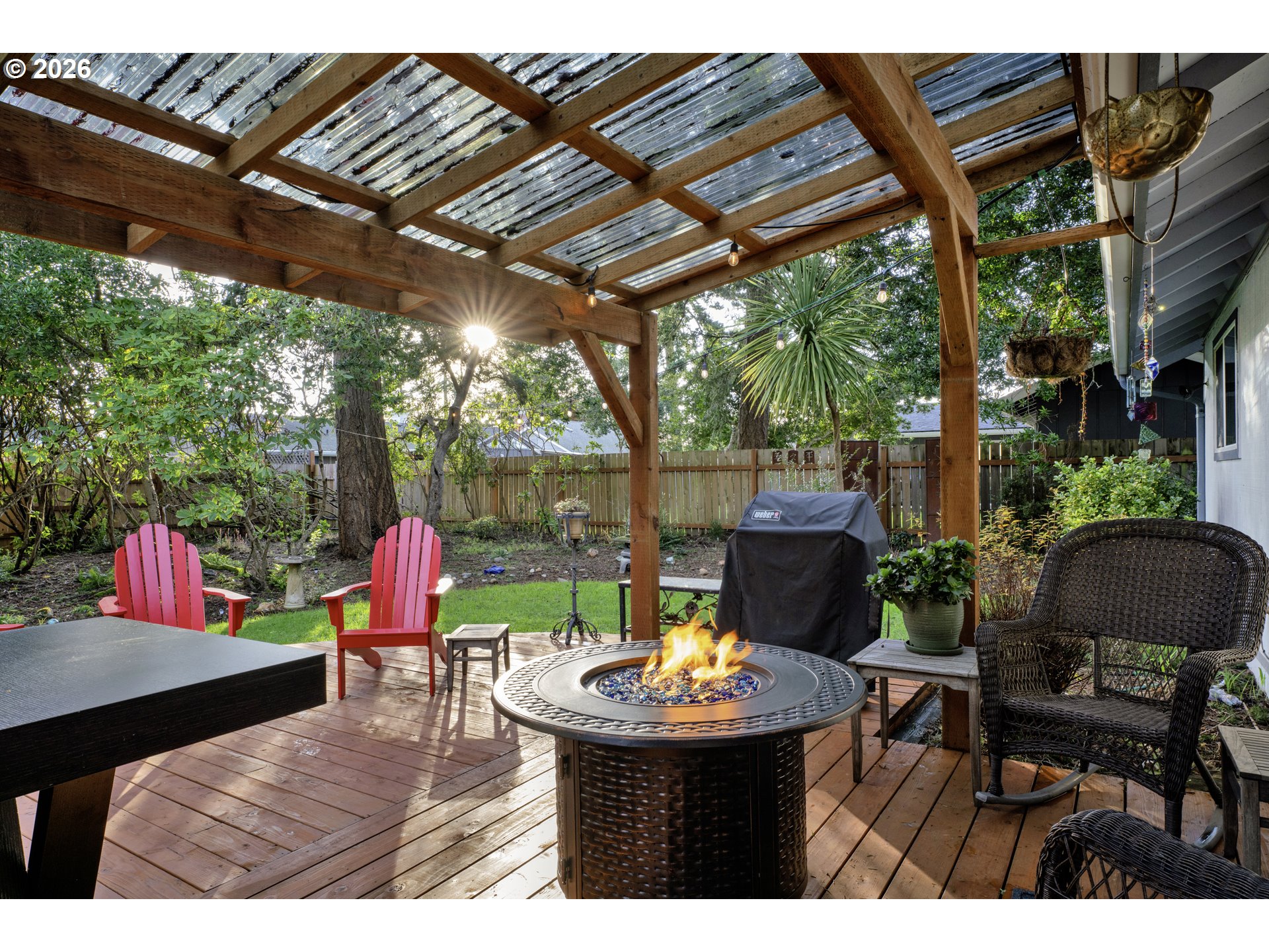 2060 20th Street Florence, OR 97439 - Photo 28 of 37 a view of yard with a table and chairs under an umbrella with a small yard