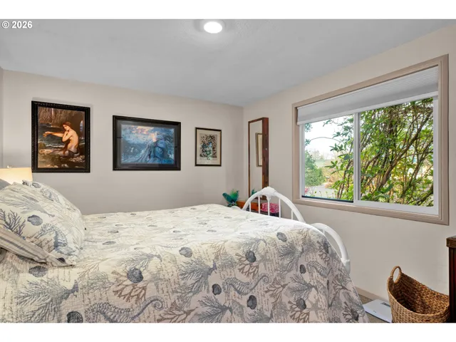 a bedroom with a large bed and a window