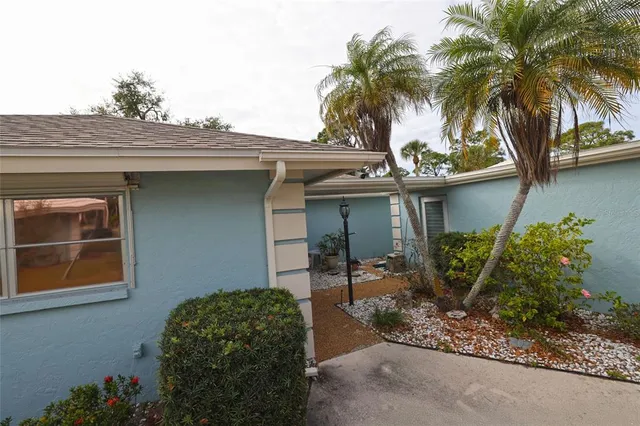 a view of a house with a backyard and a tree