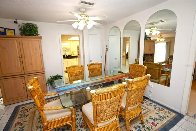 a living room with furniture a chandelier and a flat screen tv