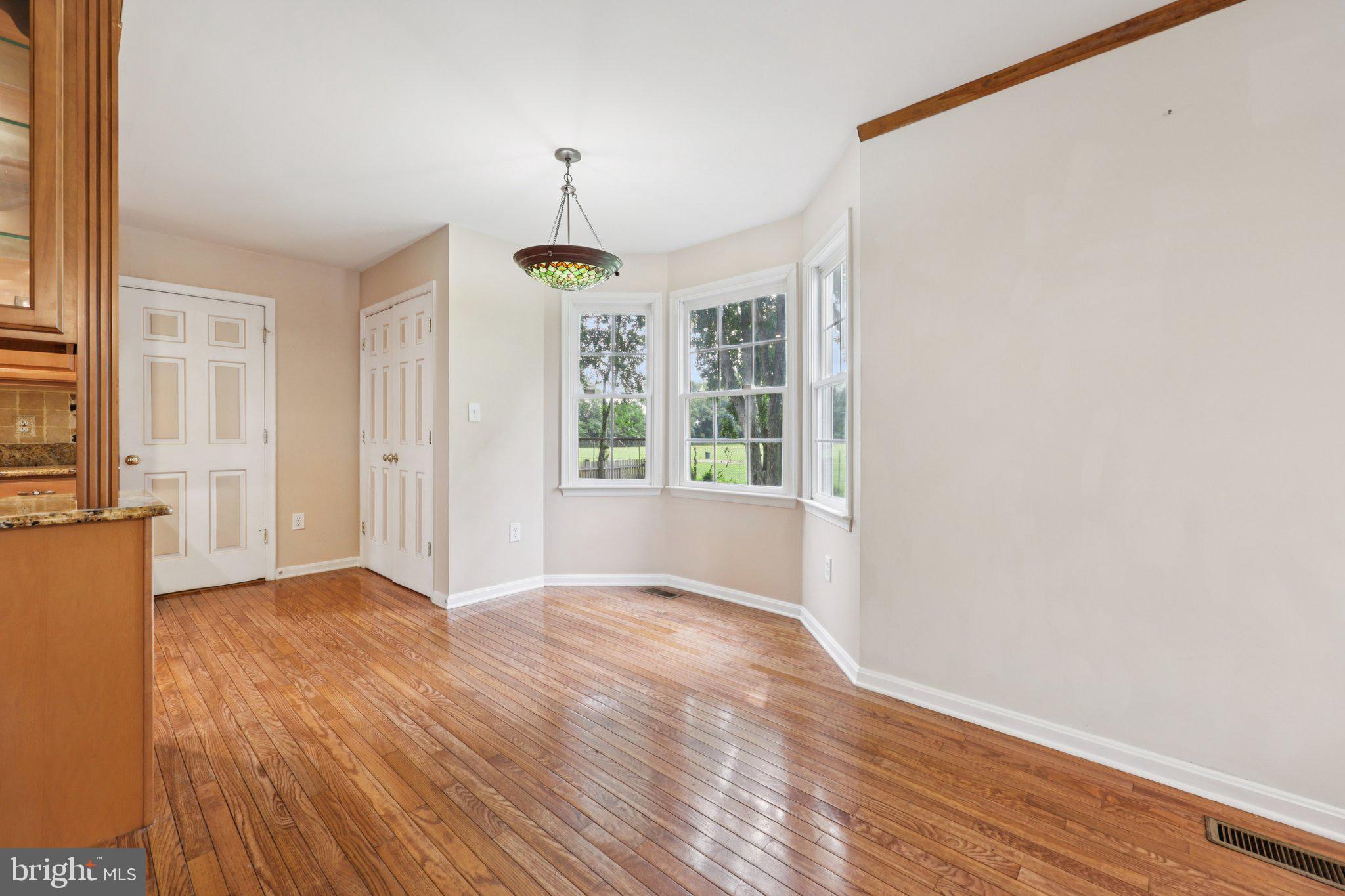 11607 River Meadows Way Fredericksburg, VA 22408 - Photo 15 of 67 a view of an empty room with a window and wooden floor