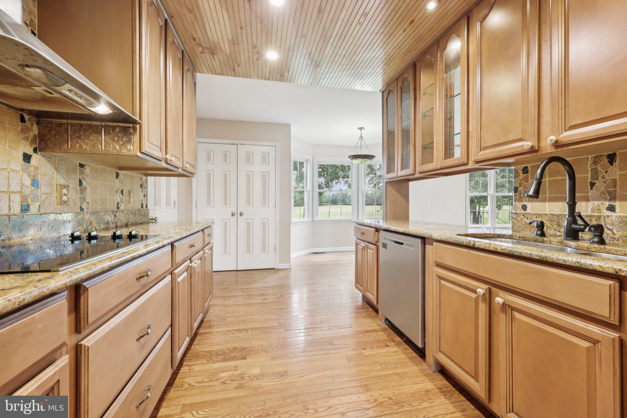 11607 River Meadows Way Fredericksburg, VA 22408 - Photo 16 of 67 a kitchen with stainless steel appliances granite countertop a sink and wooden cabinets