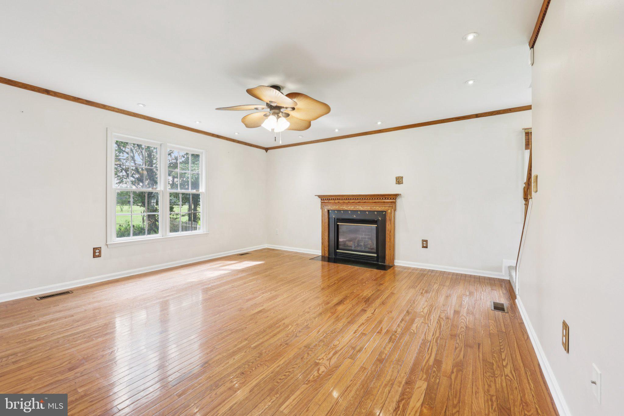 11607 River Meadows Way Fredericksburg, VA 22408 - Photo 18 of 67 a view of an empty room with a window and wooden floor