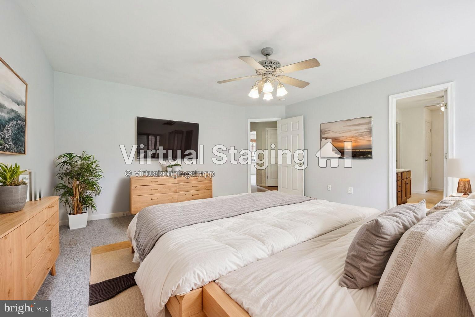 11607 River Meadows Way Fredericksburg, VA 22408 - Photo 33 of 67 a bedroom with a large bed and a chandelier