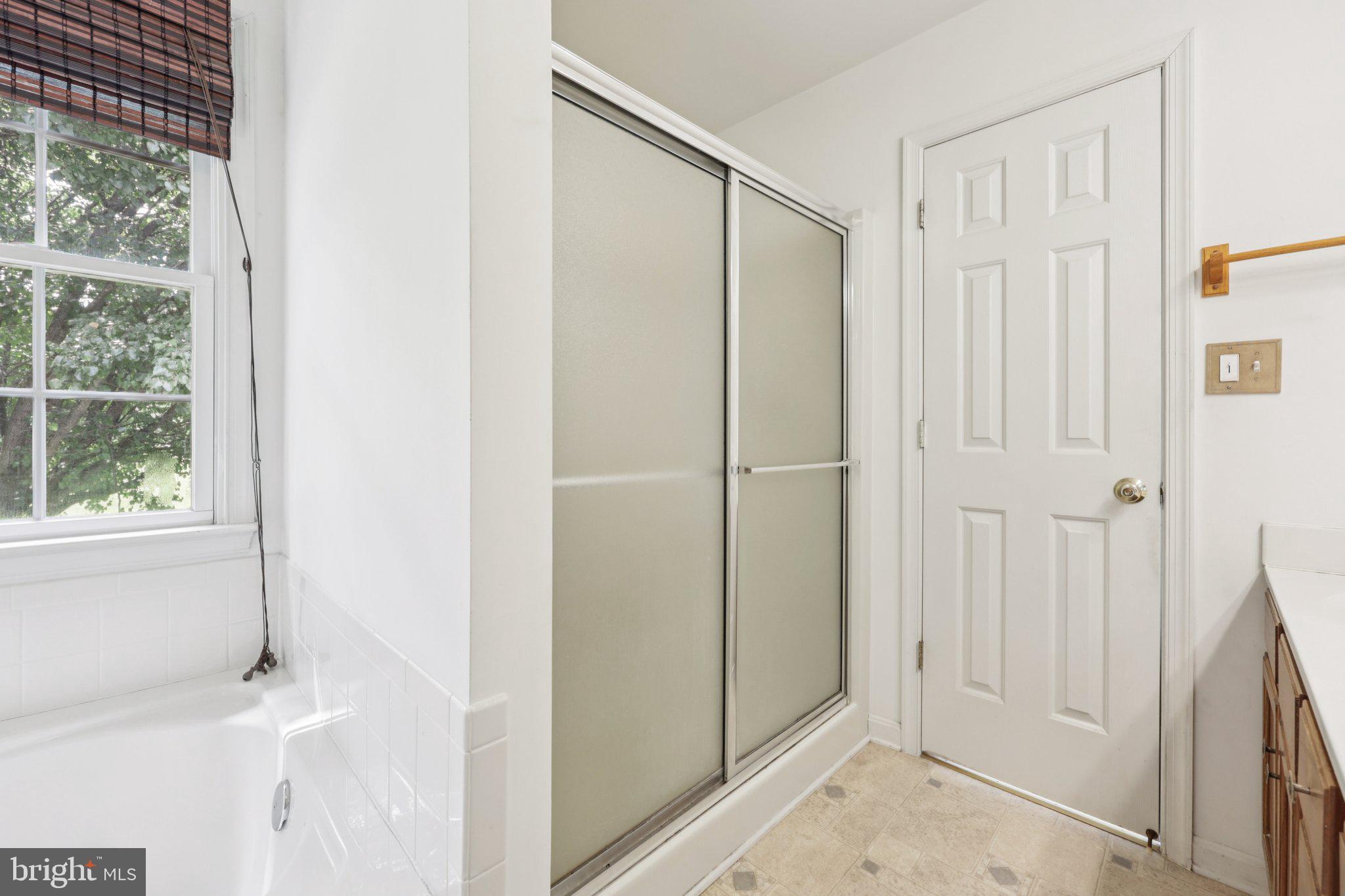 11607 River Meadows Way Fredericksburg, VA 22408 - Photo 39 of 67 a bathroom with a shower and a glass door