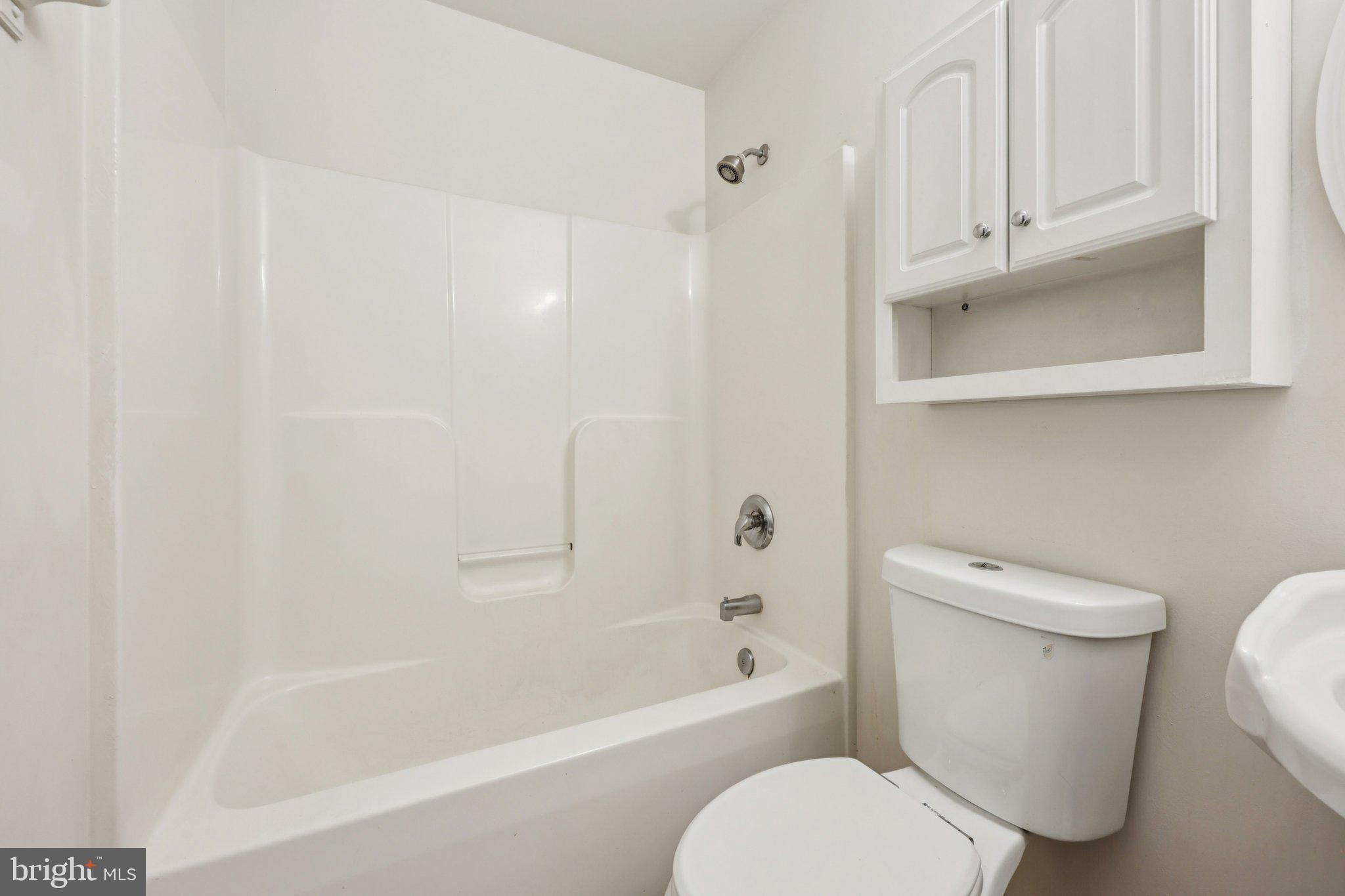 11607 River Meadows Way Fredericksburg, VA 22408 - Photo 48 of 67 a white toilet sitting next to a bath tub