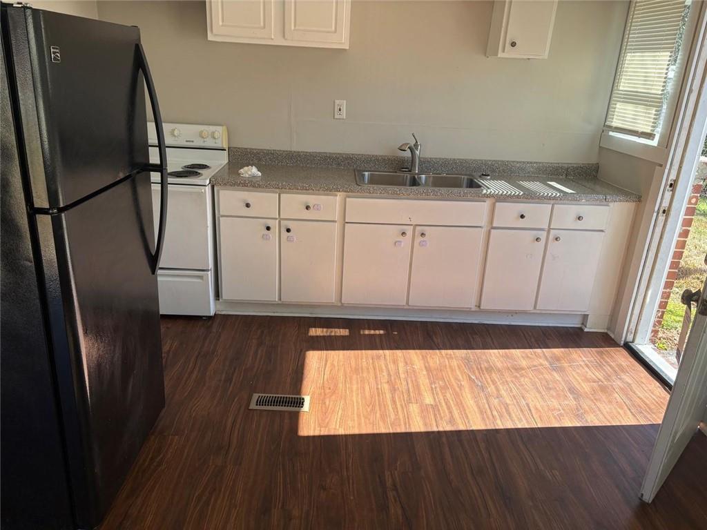 3483 Lawton Road Macon, GA 31204 - Photo 3 of 15 a kitchen with granite countertop a refrigerator a sink and wooden floor