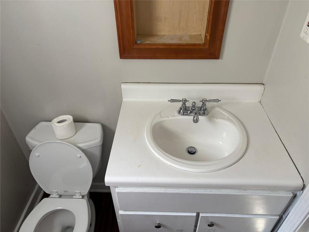 3483 Lawton Road Macon, GA 31204 - Photo 8 of 15 a bathroom with a toilet sink and mirror