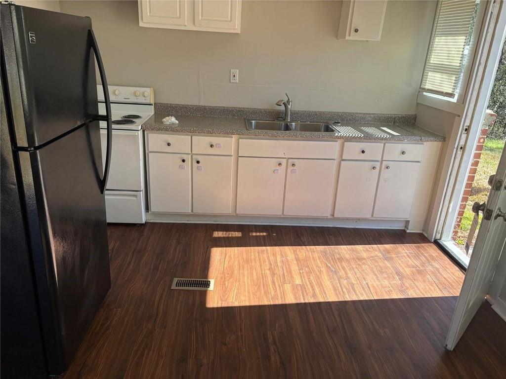 3483 Lawton Road Macon, GA 31204 - Photo 10 of 15 a kitchen with granite countertop a refrigerator a sink a stove and cabinets