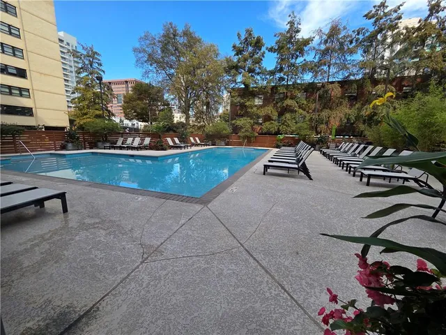 a view of a balcony with wooden floor and fence