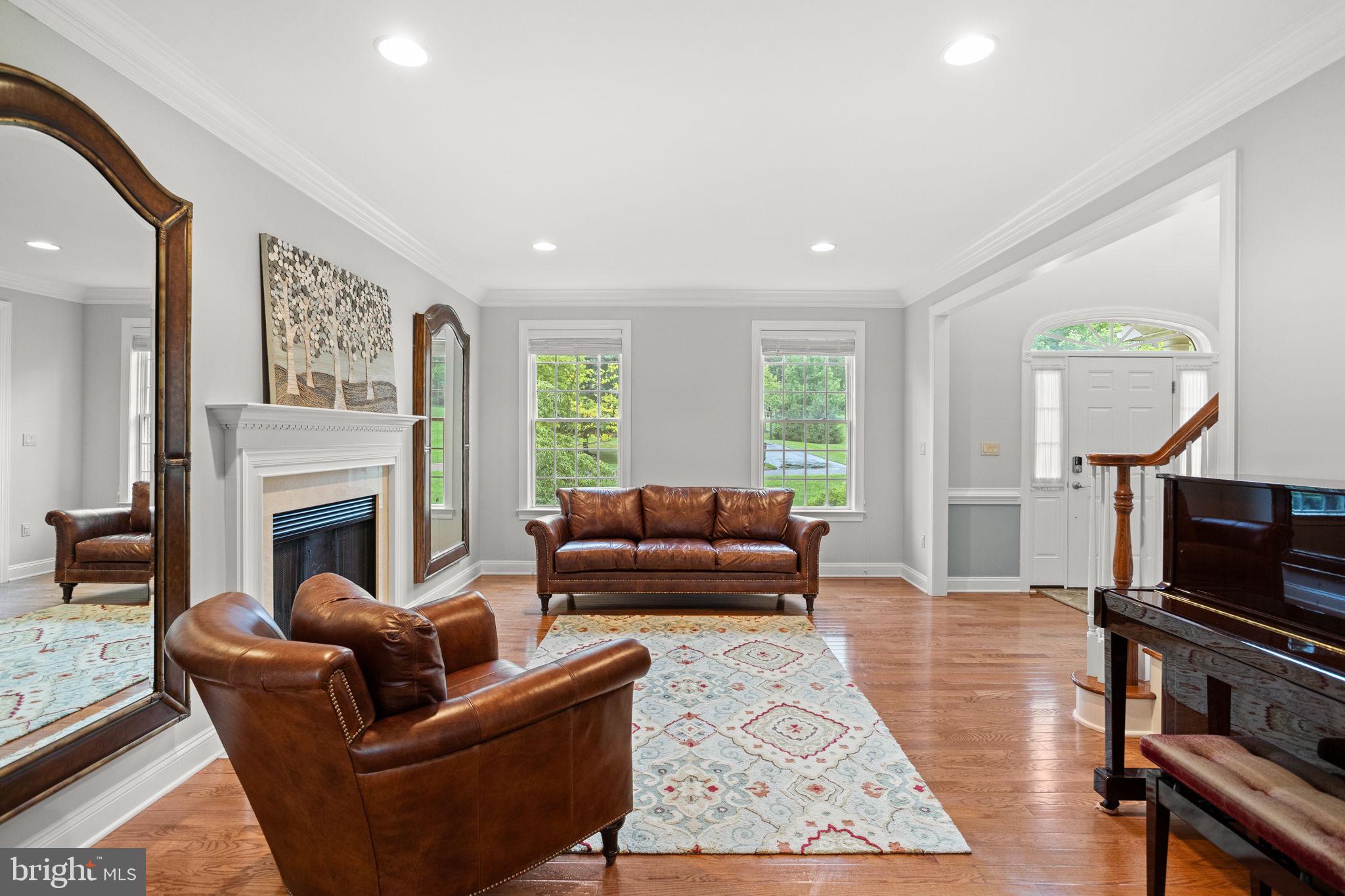1368 Spring Hill Road Eagleville, PA 19403 - Photo 14 of 66 a living room with furniture a flat screen tv and a fireplace