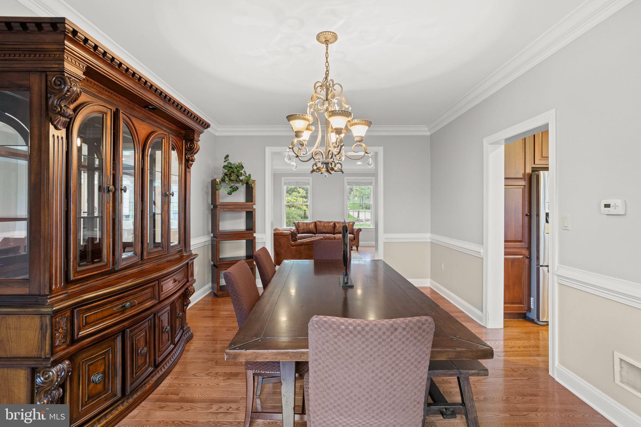 1368 Spring Hill Road Eagleville, PA 19403 - Photo 17 of 66 a dining room with furniture a chandelier and wooden floor