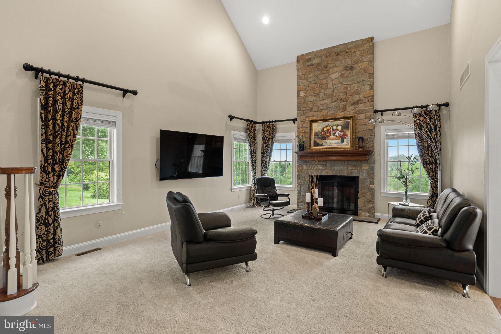 1368 Spring Hill Road Eagleville, PA 19403 - Photo 18 of 66 a living room with furniture a flat screen tv and a fireplace