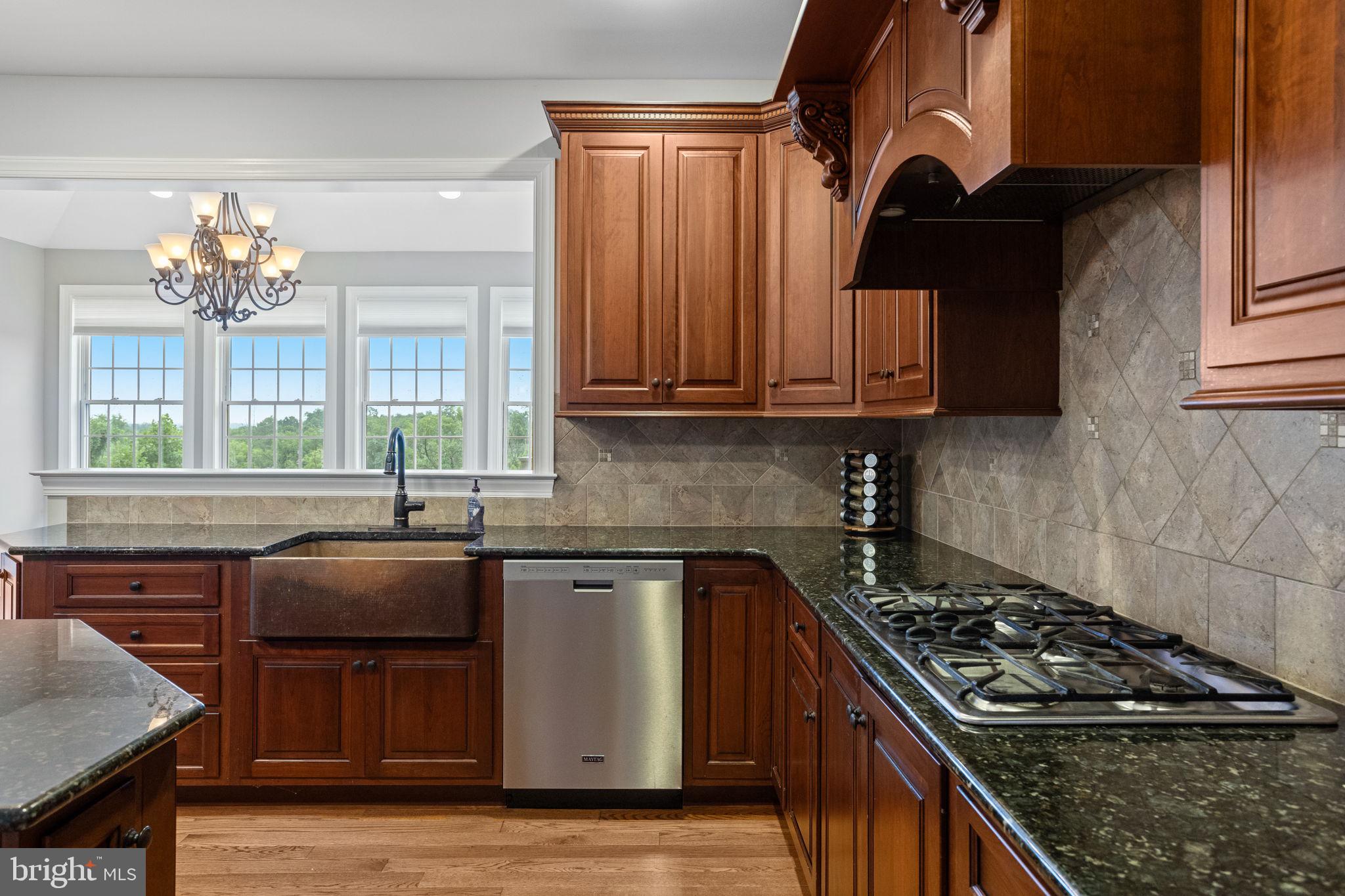 1368 Spring Hill Road Eagleville, PA 19403 - Photo 24 of 66 a kitchen with granite countertop a sink a stove and cabinets
