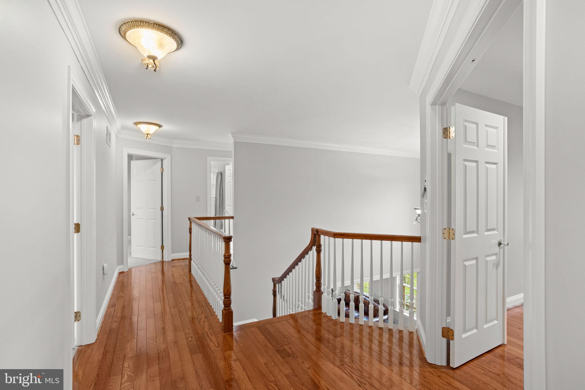 1368 Spring Hill Road Eagleville, PA 19403 - Photo 29 of 66 a view of a hallway with wooden floor and staircase