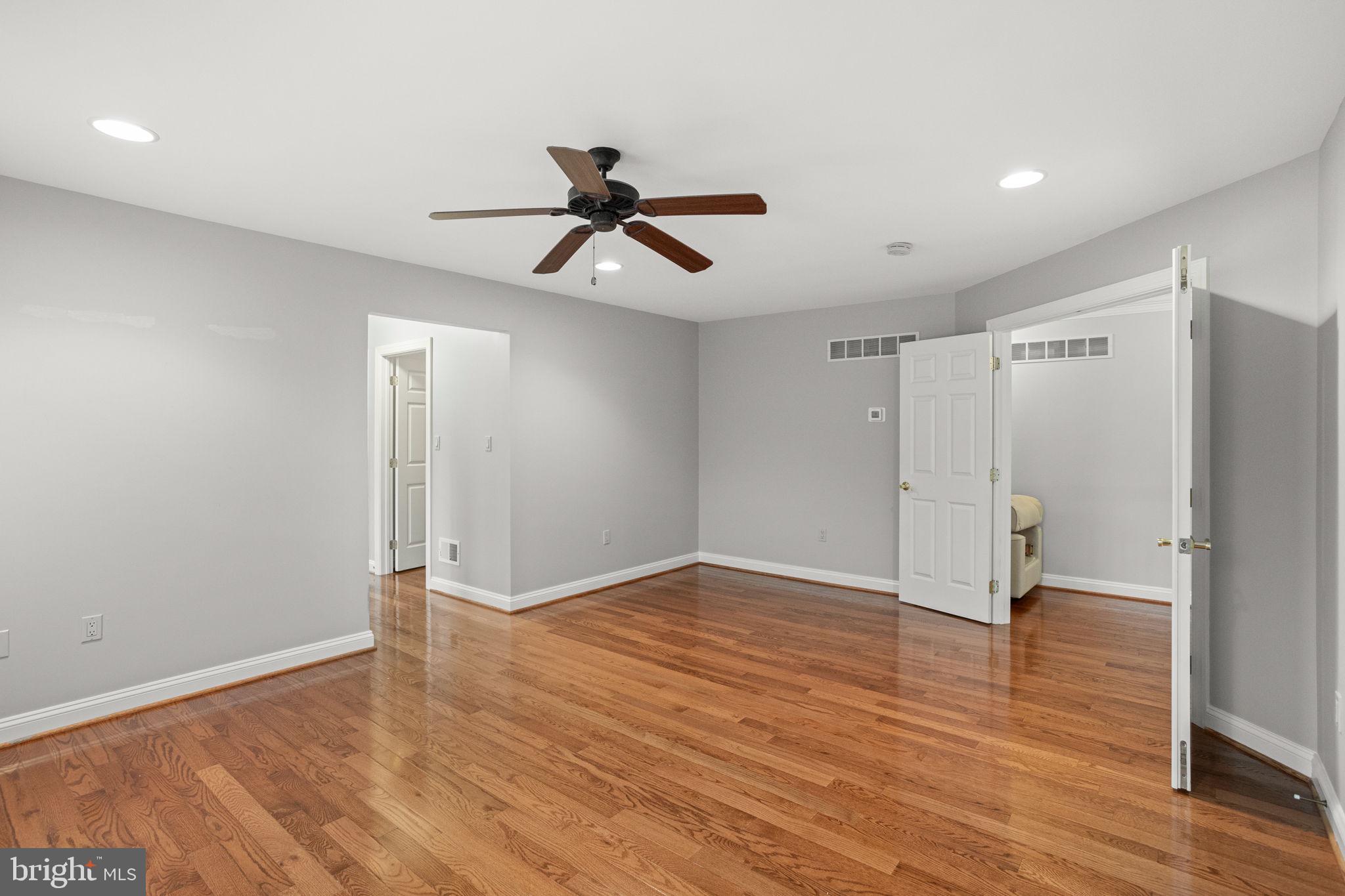 1368 Spring Hill Road Eagleville, PA 19403 - Photo 30 of 66 a view of empty room with wooden floor and ceiling fan