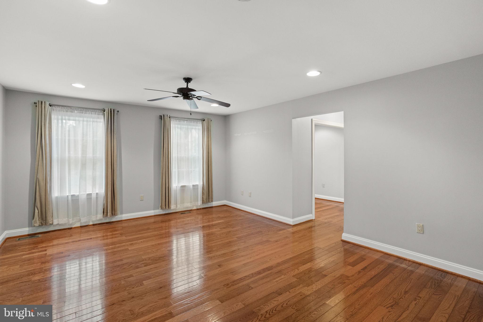 1368 Spring Hill Road Eagleville, PA 19403 - Photo 31 of 66 a view of an empty room with window and wooden floor