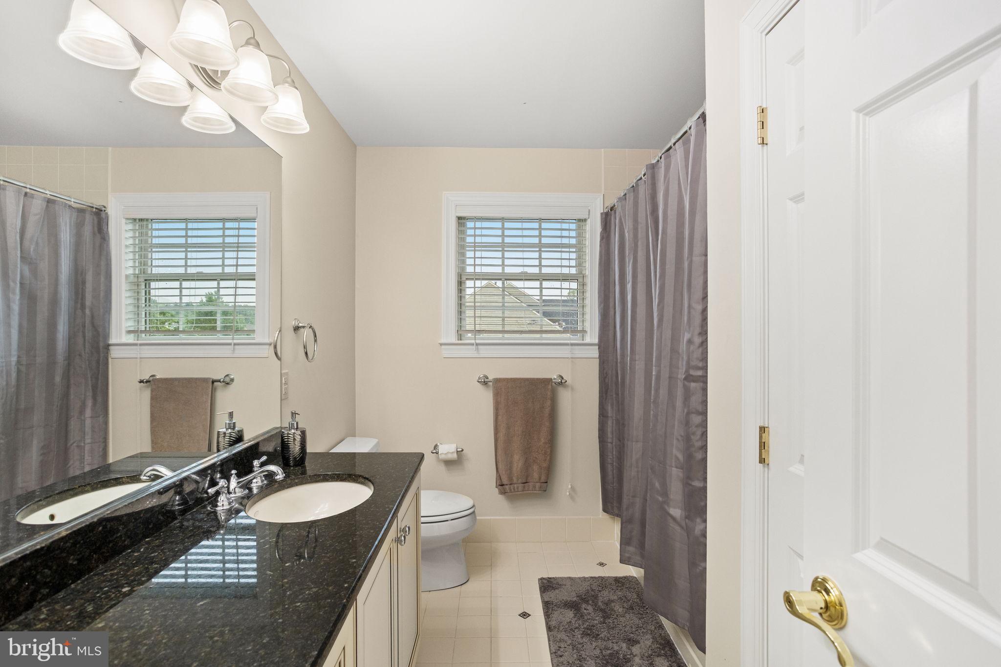 1368 Spring Hill Road Eagleville, PA 19403 - Photo 42 of 66 a bathroom with a sink a vanity and a mirror