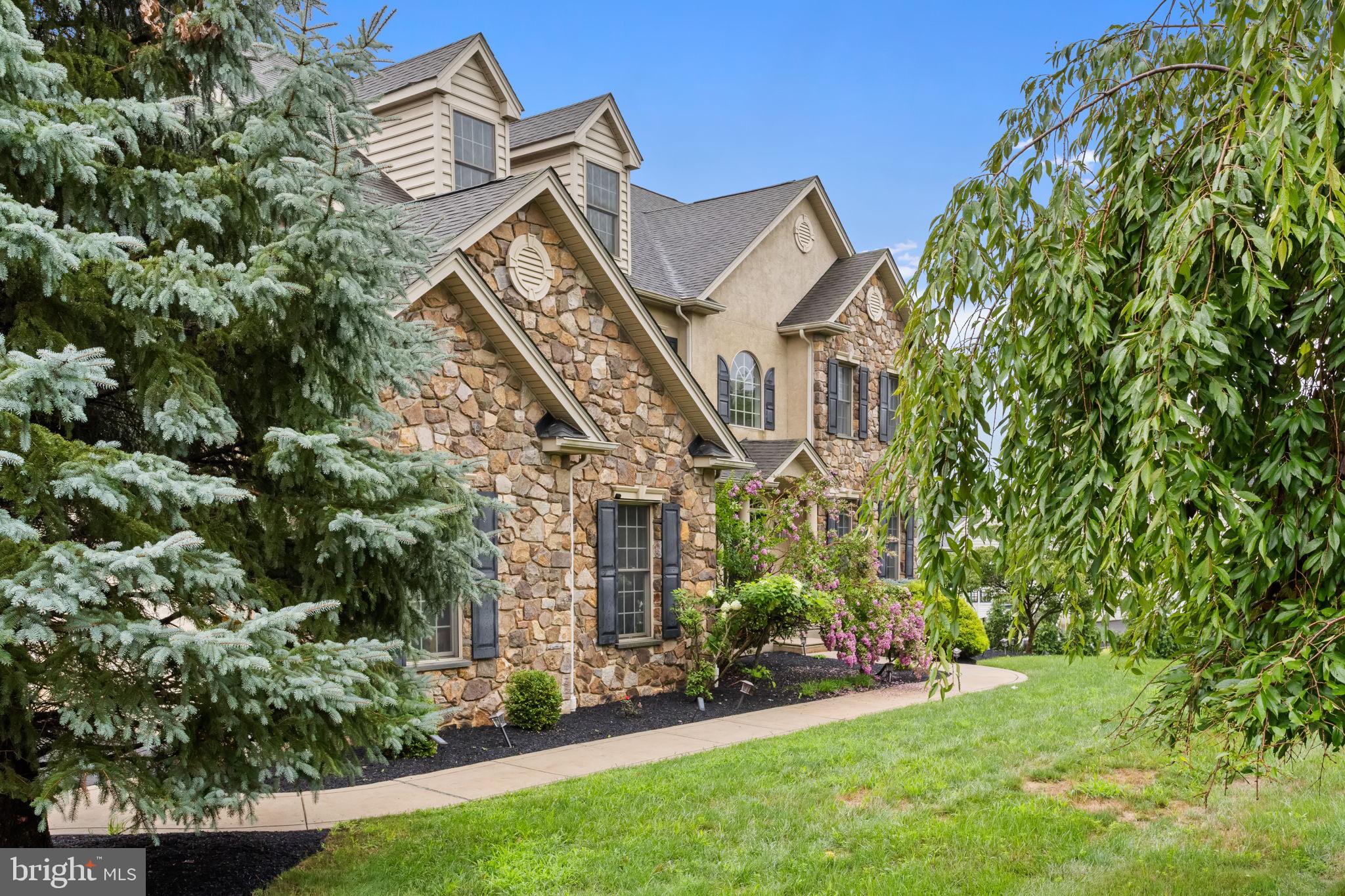 1368 Spring Hill Road Eagleville, PA 19403 - Photo 5 of 66 a view of a house with a big yard and large trees