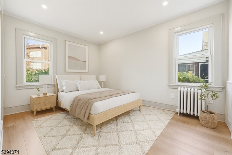 28 State Street, Unit 1 Bloomfield, NJ 07003 - Photo 5 of 8 a spacious bedroom with a bed and a window