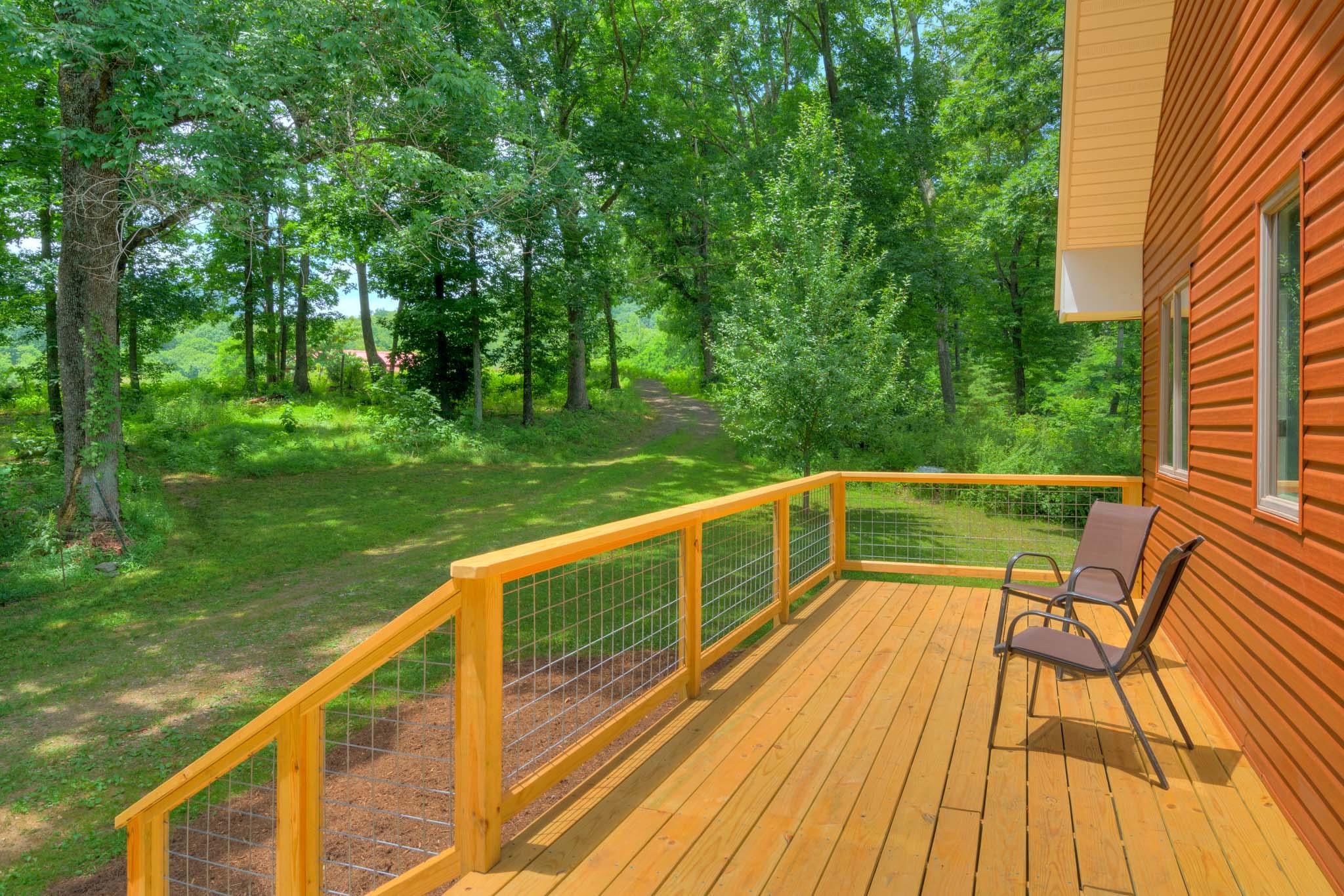 1201 Runnett Bag Road Ferrum, VA 24088 - Photo 15 of 49 a view of two chairs and a table on the wooden deck