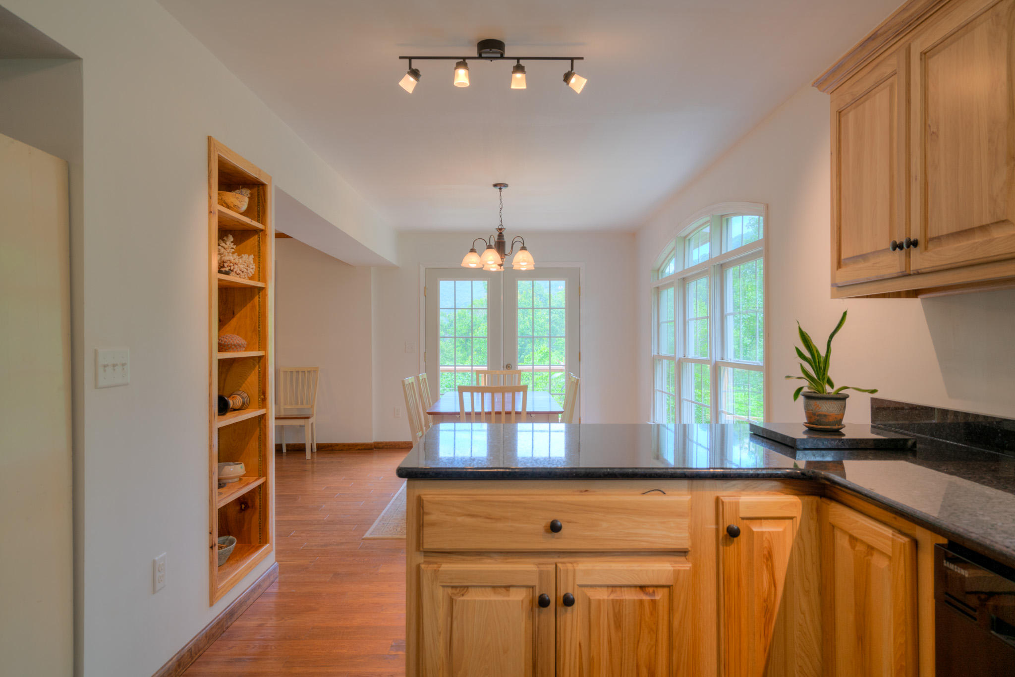1201 Runnett Bag Road Ferrum, VA 24088 - Photo 20 of 49 a kitchen with stainless steel appliances granite countertop a refrigerator a sink dishwasher a stove and a dining table with wooden floor