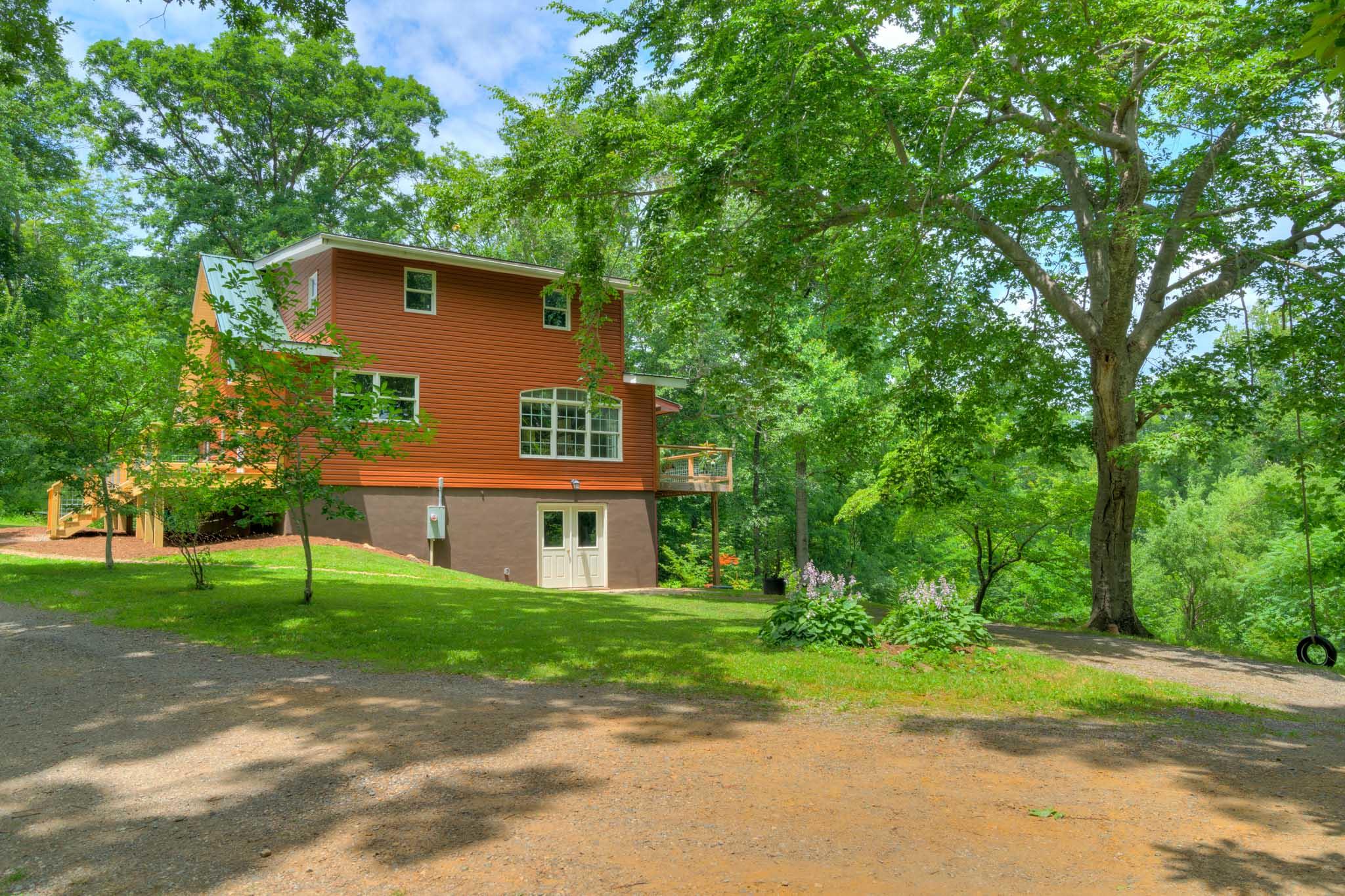 1201 Runnett Bag Road Ferrum, VA 24088 - Photo 8 of 49 a house that has a tree in front of it