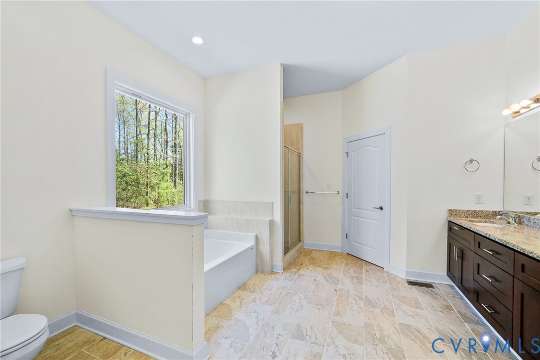 15430 River Road Chesterfield, VA 23838 - Photo 14 of 46 a spacious bathroom with a granite countertop sink a mirror and a bathtub