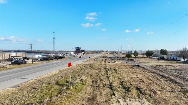 a view of a dry yard with trees
