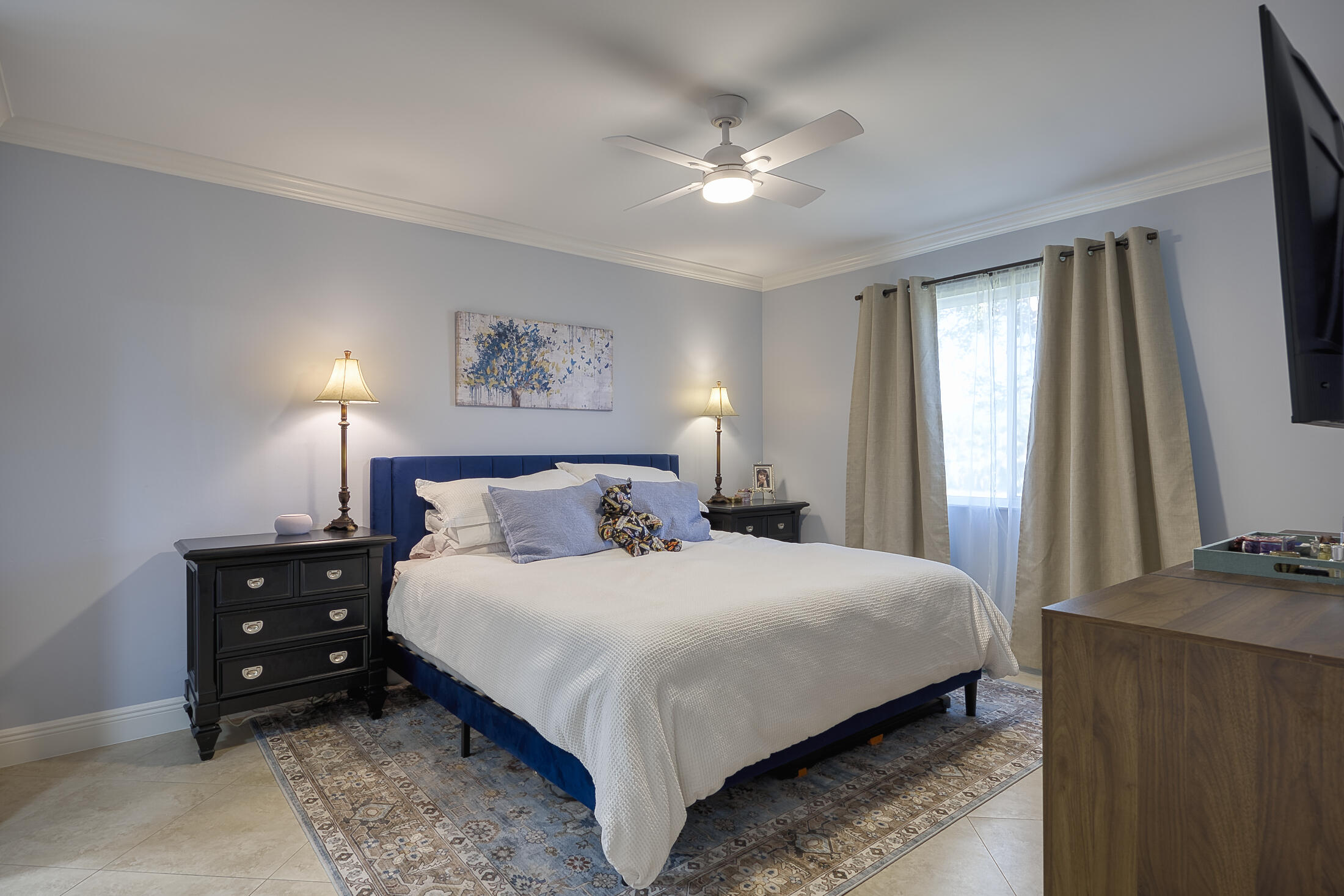 380 Northwest 67th Street, Unit 101 Boca Raton, FL 33487 - Photo 18 of 44 a bedroom with a bed and a chandelier