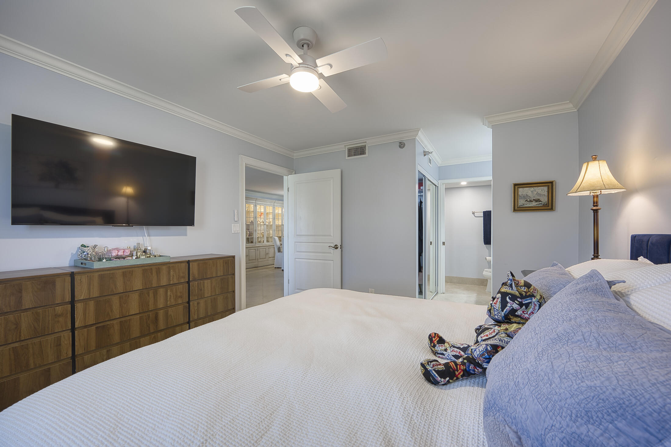 380 Northwest 67th Street, Unit 101 Boca Raton, FL 33487 - Photo 20 of 44 a bedroom with a bed and a flat screen tv in it