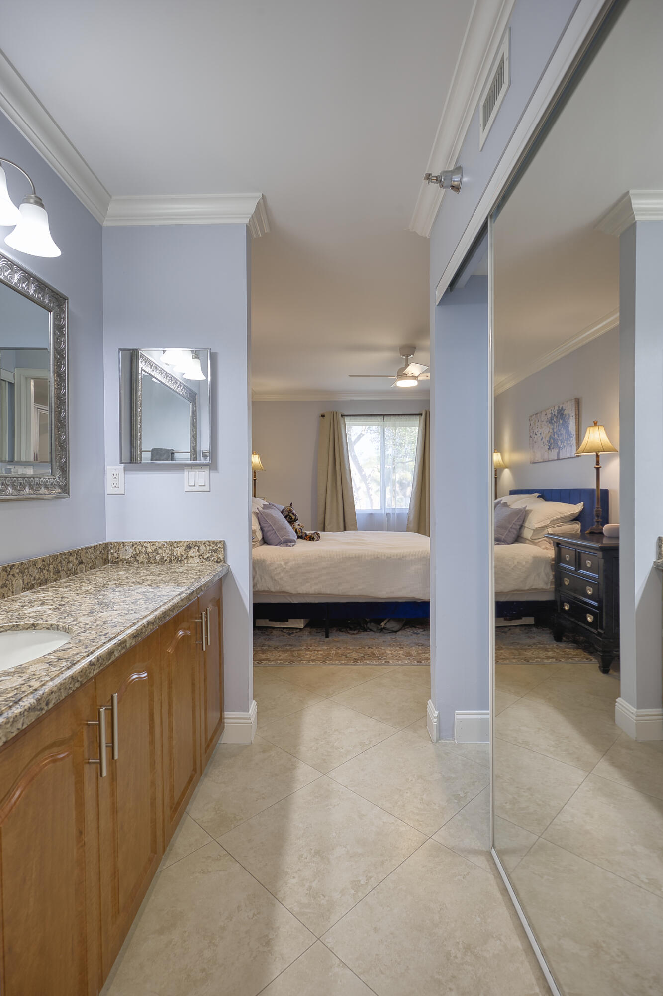 380 Northwest 67th Street, Unit 101 Boca Raton, FL 33487 - Photo 24 of 44 a spacious bathroom with a granite countertop sink and a mirror