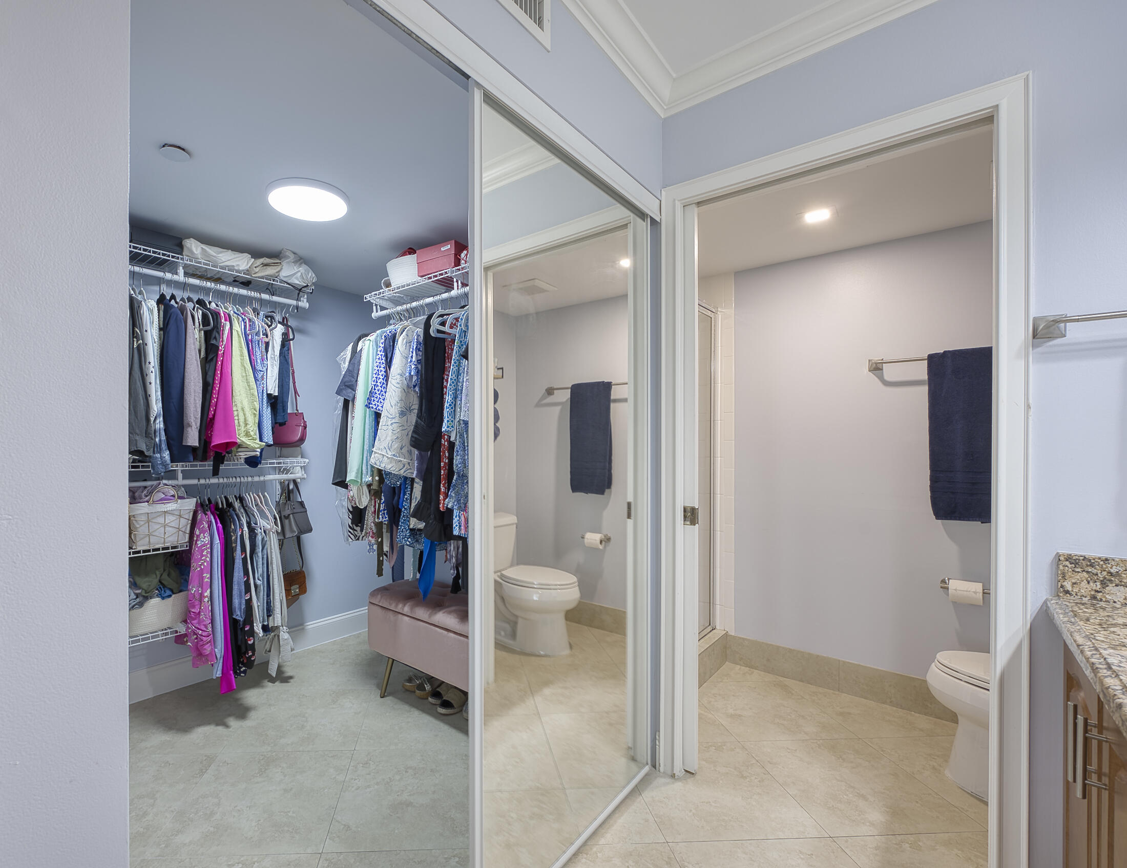 380 Northwest 67th Street, Unit 101 Boca Raton, FL 33487 - Photo 25 of 44 a view of walk in closet with clothes and shoes