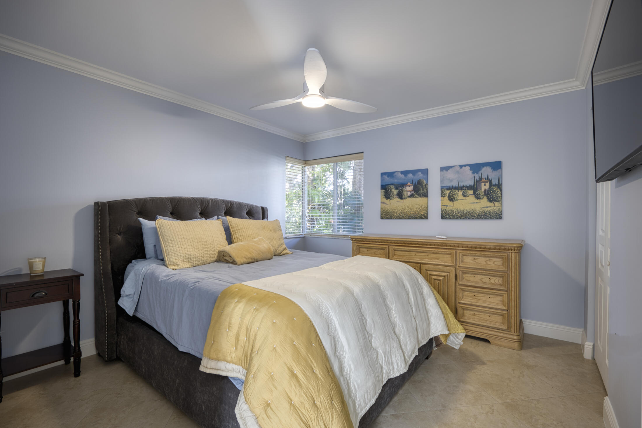 380 Northwest 67th Street, Unit 101 Boca Raton, FL 33487 - Photo 27 of 44 a bedroom with bed and a chandelier